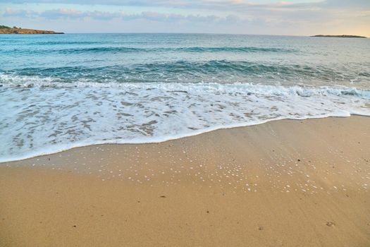 Seascape at sunrise, sea background, foam, sand dawn beach waves