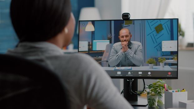 African american woman discussing communication univeristy project explaining marketing ideas during online videocall conference meeting teleconference. Computer user student working remote from home