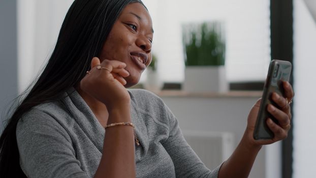 African american student talking with friend explaining online math lesson during digital videocall conference meeting. Woman with dark skin working remote from home using elearning university platform