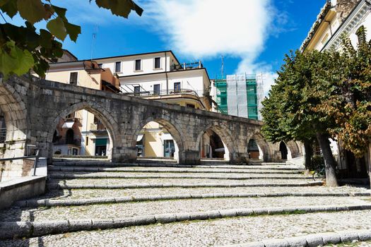 Part of the medieval aqueduct in Sulmona Garibaldi square , Italy , beautiful stone staircase