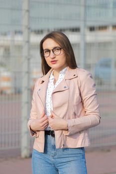 Young sexy girl standing on the street wearing trendy eyeglasses