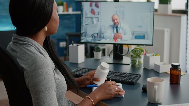 Sick woman patient discussing pills treatment for respiratory sickness with therapist during healthcare videocall conference meeting. Physician having online appointment explaining illness symptoms