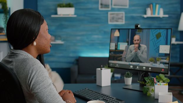 Black student waving her entrepreneur working at academic elearning course platform during online videocall conference meeting. Overworked woman having virtual marketing teleconference telework