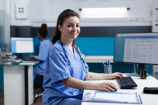 Portrait of pharmacist nurse typing medical prescription checking pharmaceutical medication expertise on computer. Woman asisstance working in hospital office. Healthcare check