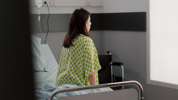 Asisstant with dark skin checking hospitalized patient with breathing disorder recovering after medical sickness. Afro american nurse working in hospital ward discussing treatment with patient