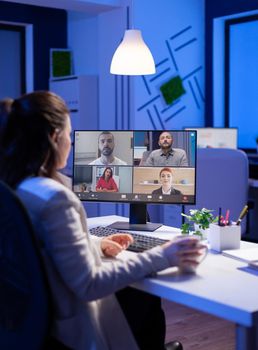 Start up manager working overtime late at night from business office talking online via web internet conference call with partners. Freelacner on videoconference corporate meeting using videocall chat