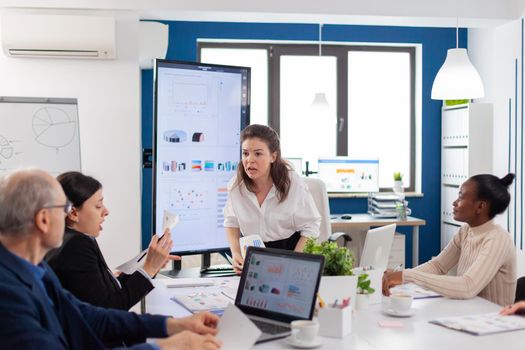 Company boss screaming at senior employee during meeting with in conference room. Shocked african woman. Businesswoman raging about multitasking difficult job, screaming in boardroom