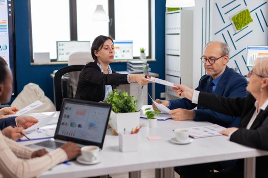 Group of diverse business people having a meeting in conference room. Businesswoman discussing ideas with colleagues about financial strategy for new start up company.