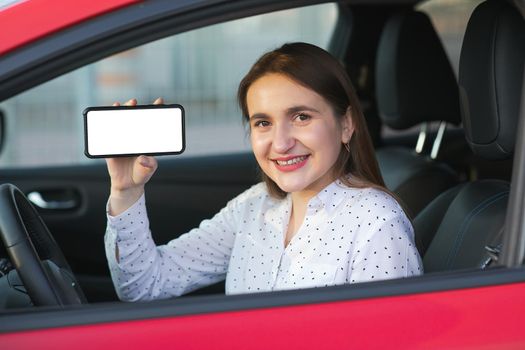 Charging Electric car and Looking at App On Mobile Phone. Close up of smartphone screen. Hand holding smart device with white display. Mobile application for eco transportation.