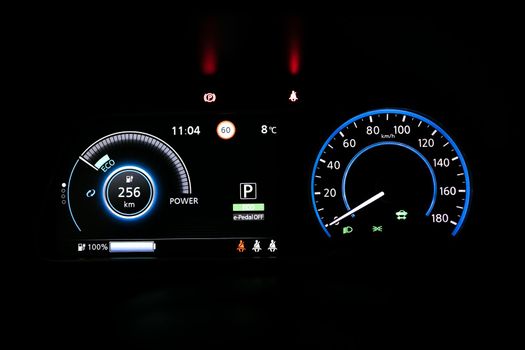 Starting electric car Dashboard. Track in to the button. Finger press the button to start the car engine. Car dashboard during start engine on the darkness. Electric car dashboard with backlight