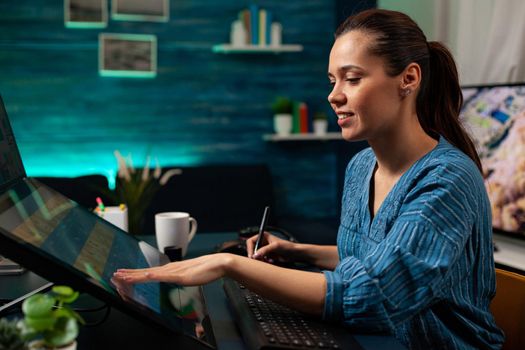 Graphic software editor working on touchpad monitor computer to retouch lights and gradient on photo at modern office. Artistic woman using photo retouching template for digital project