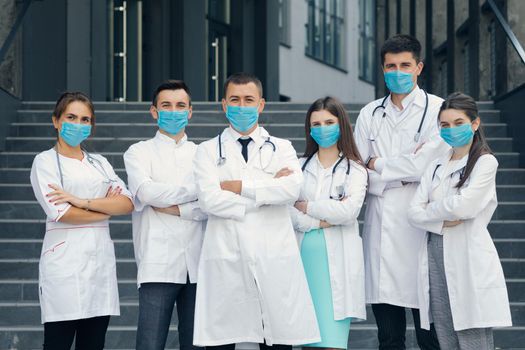 Group of Doctors With Face Masks Looking at Camera. Teamwork Specialist Doctors . Corona Virus and Healthcare Concept.