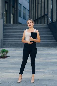 Portrait of Successful businesswoman standing outdoors near office building