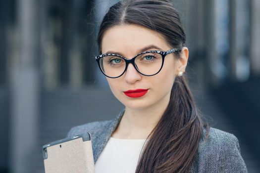 Close-up portrait of young woman wearing glasses. Make-up. Optics, eyewear. Portrait of young businesswoman wearing glasses.