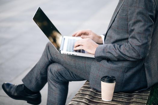 Freelancer's hands typing on laptop keyboard. Businessman working with internet. Man searches new job on internet. Business concept. Unemployment. Lack of jobs. Financial crisis.