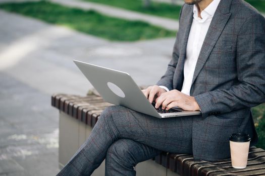 Businessman working with internet. Man searches new job on internet. Business concept. Unemployment. Lack of jobs. Financial crisis. Freelancer's hands typing on laptop keyboard.