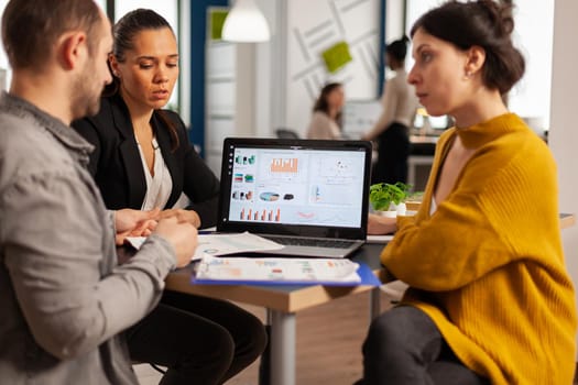 Business people talking with team leader using clipboard with documents pointing on it, presenting startup financial ideas to manager, brainstorming project management strategy in company office