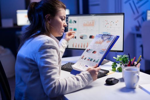 Focused businesswoman checking graphics from nootebook, working at financial strategy from office worker. Busy manager using modern technology network wireless searching business solution