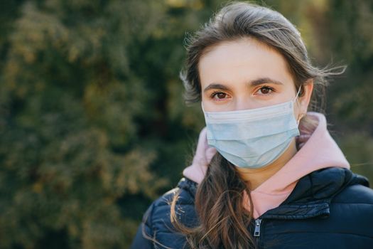 Girl Wearing Medical Mask During Coronavirus COVID-19 Epidemic. Concept of health and safety life, N1H1 coronavirus, virus protection.