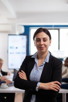Woman entrepreneur smiling at camera standing in conference room, preparing for meeting with partners. Manager working in professional start up financial business, modern company workplace ready for meeting.