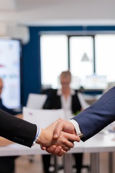 Satisfied businessman company employer wearing suit handshake in conference room , workplace. Man hr manager employ successful candidate shake hand at business meeting, placement concept