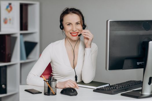 Support and Operator Service Business Representative Concept. Young Beautiful Women Call Center Wear Headset and Working with Computer while Consulting Customer with Online Problem.