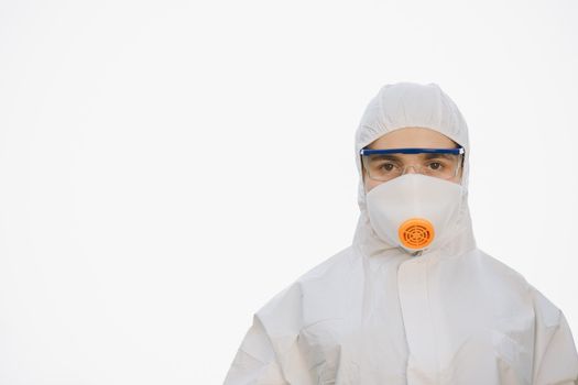 Worker in chemical protective suit on a white background. Female doctor in protective suit, face mask and red glasses. Paramedic upset woman on white background.