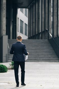 Excited man trainee new employee on first day at work carrying box with stuff to his new workplace. Concept of work,career and success.