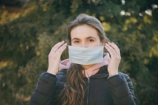 Beautiful Girl Wearing Medical Mask During Coronavirus COVID-19 Epidemic. Concept of health and safety life, N1H1 coronavirus, virus protection.