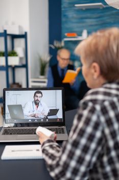 Sick senior woman talking with young doctor during remote consultation. Elderly telemedicine online conference call with practitioner doctor using modern healthcare technology, web diagnosis