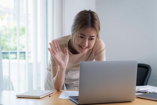 Businesswoman in having a video call on laptop while discussion with business partner during work from home