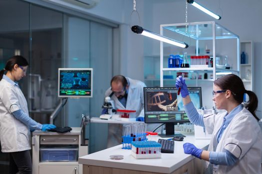 Team of scientific researchers working with professional modern equipment in laboratory. Chemists in pharmaceutical lab examining sample for medical experiment with technology for medicine industry.