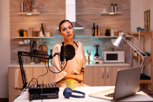 Woman speaking during online show into professional microphone. Creative online show On-air production internet broadcast host streaming live content, recording digital social media communication