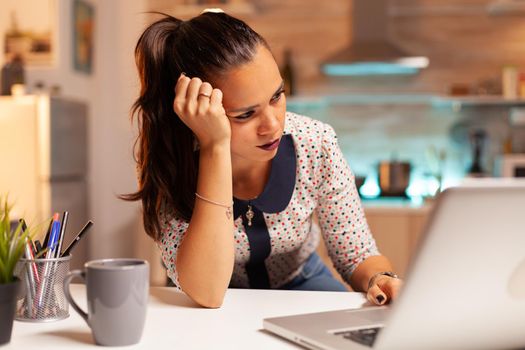 Woman having a headache while trying to finish a project before deadline. Employee using modern technology at midnight doing overtime for job, business, busy, career, network, lifestyle ,wireless.