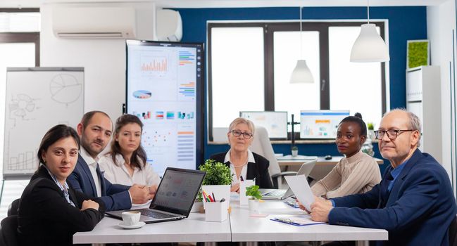 Pov of diverse team sitting in conference room during virtual meeting, discussing online with business partners. Internet conference call technology talk with investors, corporate brainstorming via web.