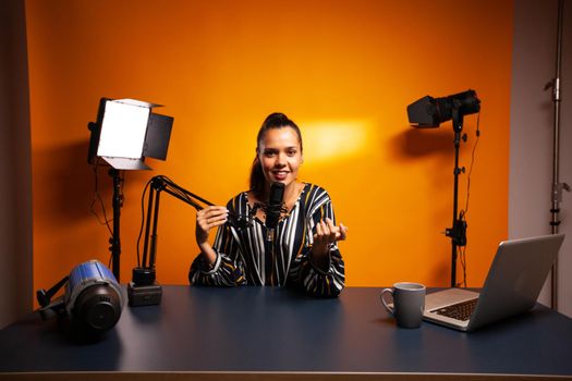 Vlogger recording video using professional microphone. Content creator new media star on social media recording for internet web online subscribers audience new podcast episode