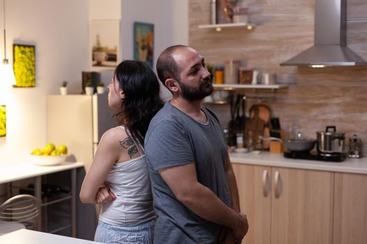 Caucasian couple having marriage problems and fighting at home. Angry man and irritated woman in relationship arguing about jealousy feeling unhappy and frustrated about scandal