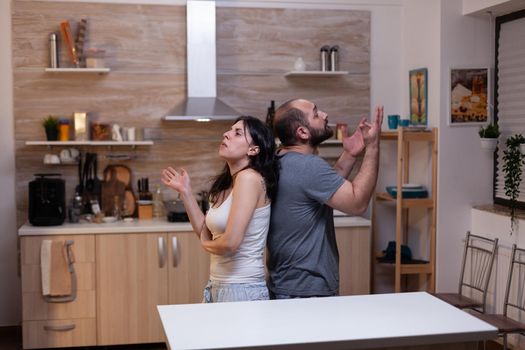 Caucasian couple having marriage problems and fighting at home. Angry man and irritated woman in relationship arguing about jealousy feeling unhappy and frustrated about scandal
