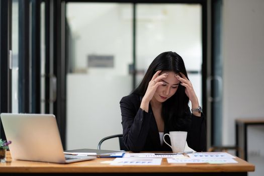 Beautiful asian businesswoman tired from work in the office, Woman feeling stress from work.