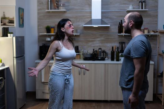 Furious husband and wife shouting and arguing having social marriage problems. Violent aggressive man yelling at bruised angry woman, couple dealing with domestic violence and conflict