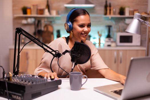 Speaking into professional microphone during podcast in home studio. Creative online show On-air production internet broadcast host streaming live content, recording digital social media communication