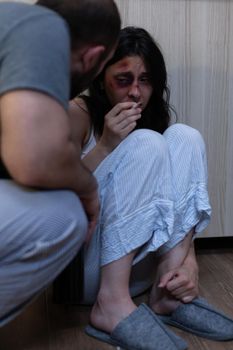 Abusive alcoholic husband harassing terrified wife with bruises being victim of domestic violence in relationship. Furious man and scared woman having social problems and conflict