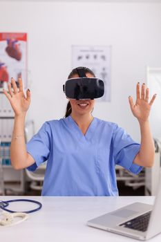Medical nurse experiencing virtual reality using vr goggles in hospital office. Therapist using medical innovation equipment device glasses, future, medicine, physician, healthcare, professioanl, vision, simulator.