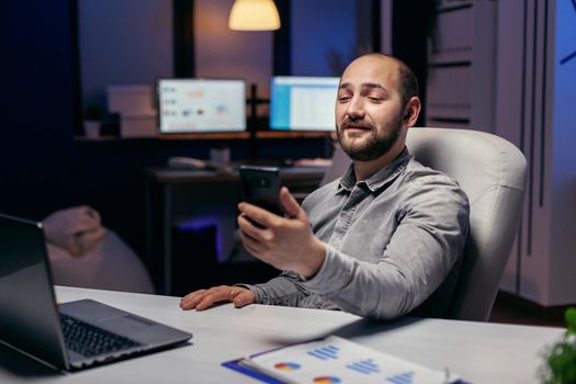 Freelancer in empty office talking on online call with someone. Businessman in the course of an important video conference while doing overtime at the office.