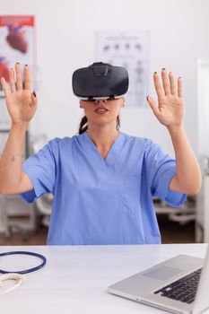Health physician using medical inovation wearing virtual reality goggles in hospital office. Therapist using medical innovation equipment device glasses, future, medicine, physician, healthcare, professioanl, vision, simulator.