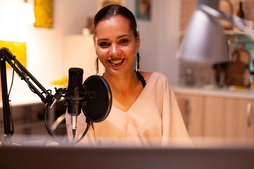Presenter recording voice in home studio for media using professional microphone. Creative online show influencer On-air online production internet broadcast show host streaming live content recording