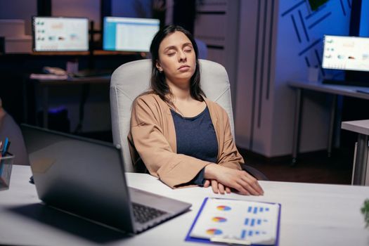 Workaholic freelancer sleeping in the course of deadline project in empty office. Employee falling asleep while working late at night alone in the office for important company project.