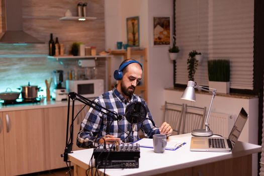 Business man recording talk show at home studio with laptop on table. reative online show On-air production internet broadcast host streaming live content, recording digital social media communication