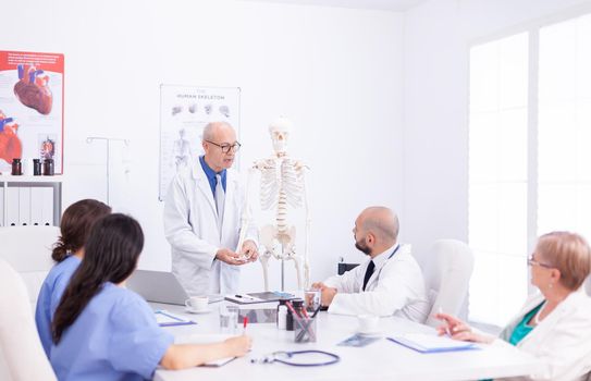 Healthcare physician holding presentation about human anatomy using. Clinic expert therapist talking with colleagues about disease, medicine professional