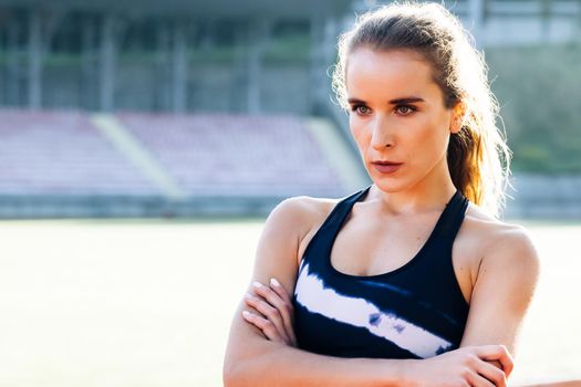 Fitness lifestyle portrait, caucasian model, trained body. Portrait of fitness woman in sport clothes professional athlete after physical training.